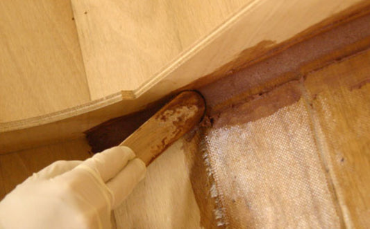 wood fillet being applied during the boat building process