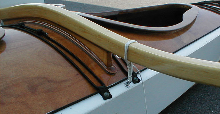 Show Full Screen The akas of the  CLC SailRig are lashed to the kayak hull.