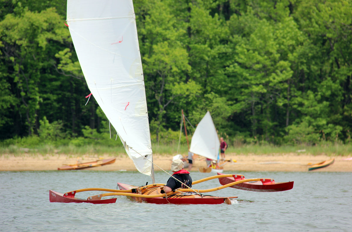 Show Full Screen Shot from port quarter of a kayak with a CLC SailRig at a recent Okoumefest.