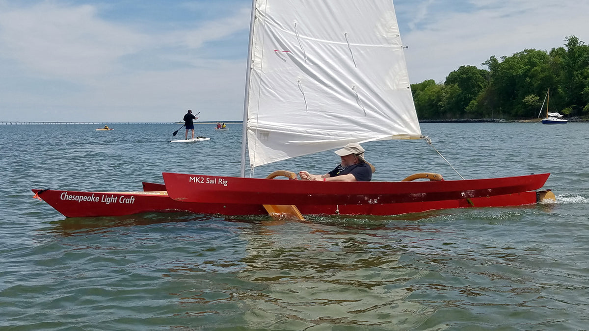 One can just see the leeboard peeking out below the windward ama as this sailor is enjoying a fast ride under a CLC SailRig.