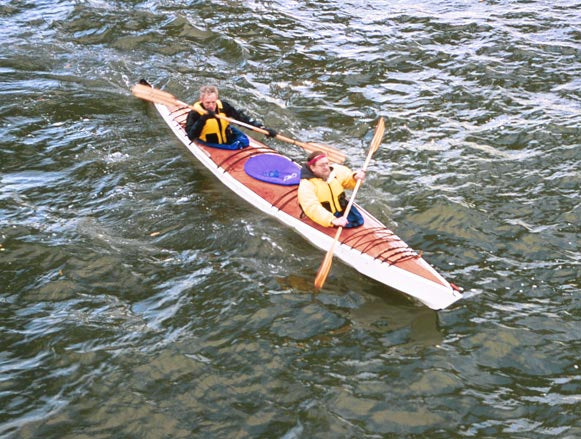 Two paddlers in a Chesapeake Triple wooden kayak