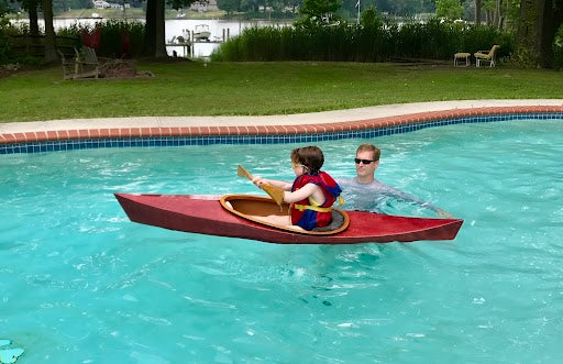 Introducing your child to kayaking in a pool minimizes risks. Ella H. is practicing the proper paddle grip.