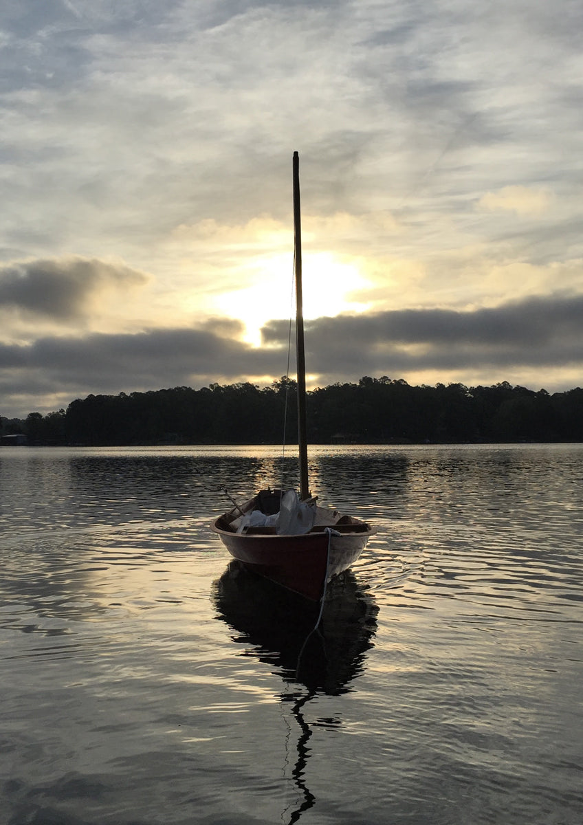 A Northeaster Dory is anchored on  Dalewood Lake, in Lauderdale, Mississippi