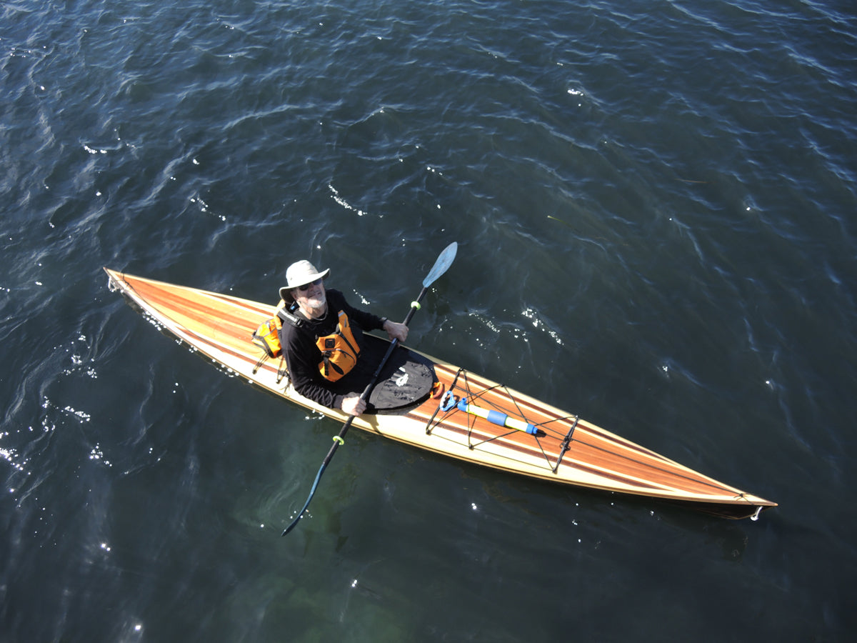 Steve H. looking skyward from his Petrel Play kayak while paddling in Monterey Bay, California.