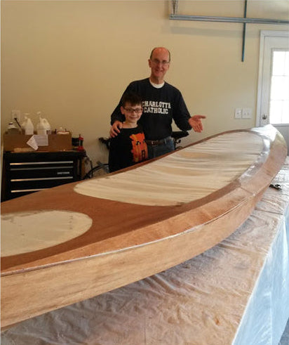 Charles M. and his son Nate show off the Wood Duck Double kayak that they built.