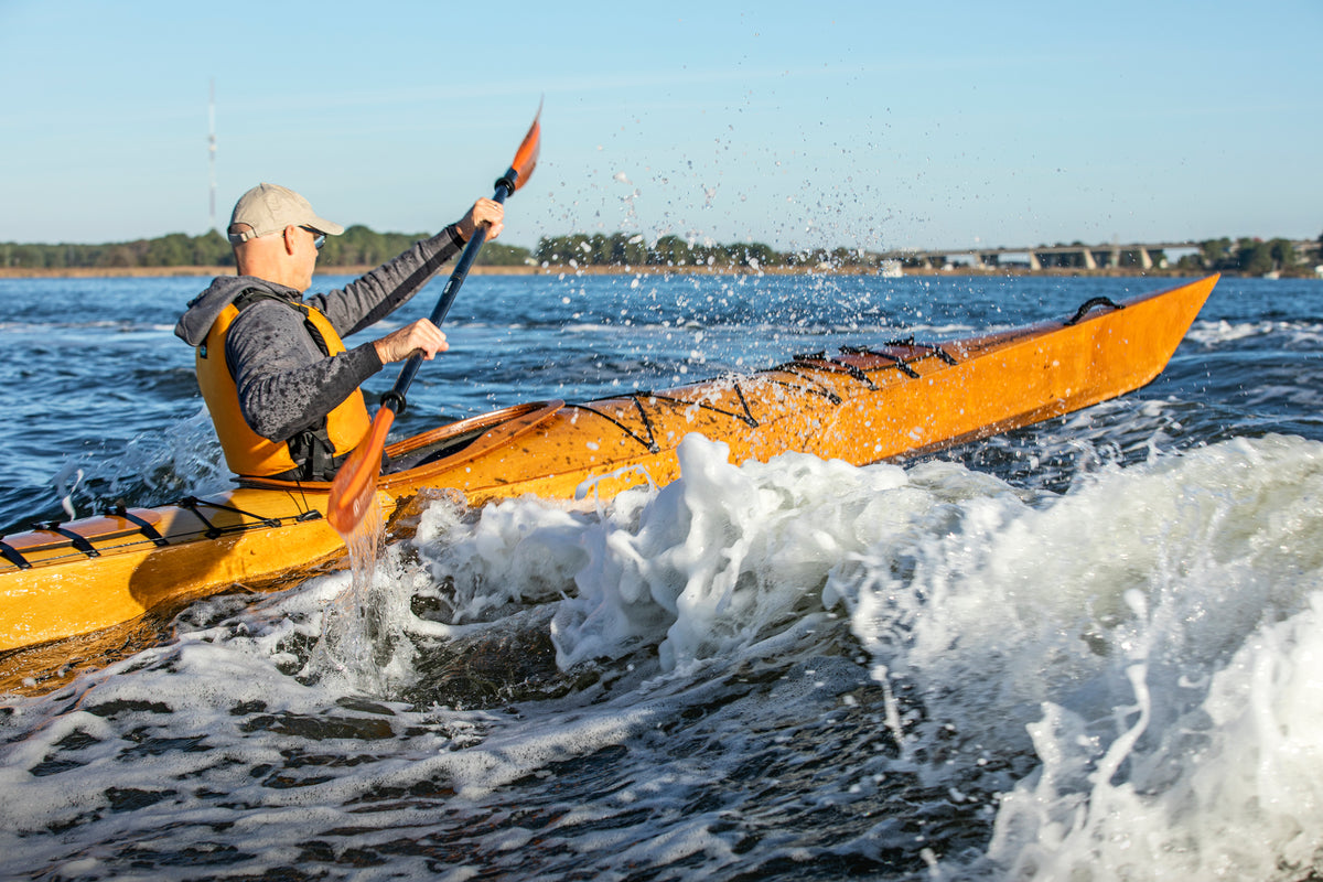 Chesapeake 17 Kayak surging through a boat's wake.