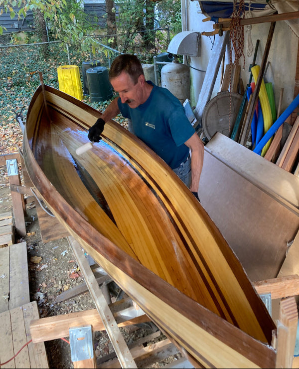 Show Full Screen Bill G. coating the cockpit of his Nymph canoe