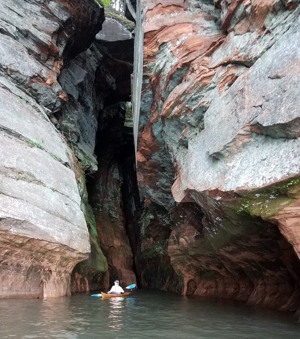 Robin W. exploring Wisconsin's sea caves on Lake Superior in his Shearwater 16 kayak.