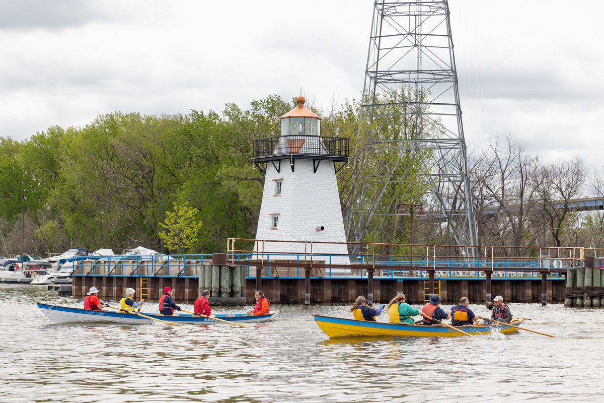 The yellow Team Dory rowed by the Wishigan Rowing Team, is seen racing in their annual Ice Out Regatta in Wisconsin. Photo credit to Mark Hawkins.