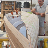 Strip-Planking the underside of a canoe hull.
