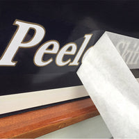 CLC vinyl lettering; White over Gold on a Peeler Skiff