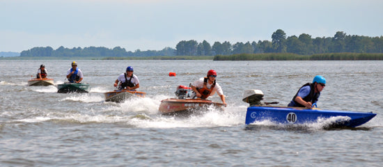 Cocktail Class Racers line up to turn around a buoy on the race course.