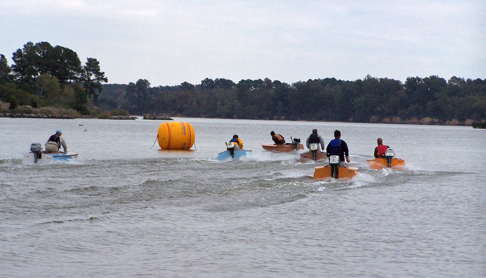 Cocktail Class Racers negotiating a turn around the large yellow buoy.