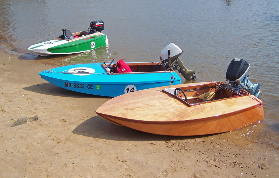 Three Cocktail Class Racers wait at the beach. The boat in the foreground was built at CLC and soon to be named DARK AND STORMY.