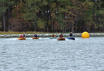 Drivers crouch over to increase the speed of Cocktail Class Racers. Aaron McWain, in the second boat from the right has taken the lead. Thumbnail