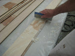 Scraping excess epoxy after gluing the puzzle joints of the strakes together. 
 Thumbnail