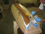 Sealing the fiberglass with epoxy on the bottom of an Annapolis Wherry Tandem. Thumbnail