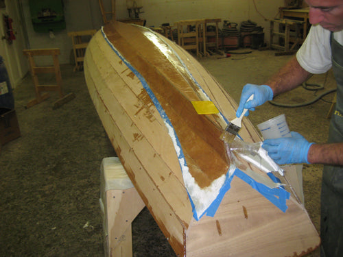 Sealing the fiberglass with epoxy on the bottom of an Annapolis Wherry Tandem.