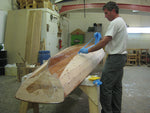 Pulling the tape from the bottom of an Annapolis Wherry Tandem after applying fiberglass to hull. Thumbnail