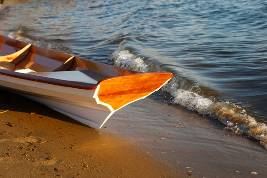 Detail of the stern of an Annapolis Wherry Tandem on a beach