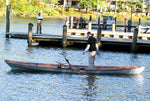 A man standing in a floating Annapolis Wherry Tandem Thumbnail
