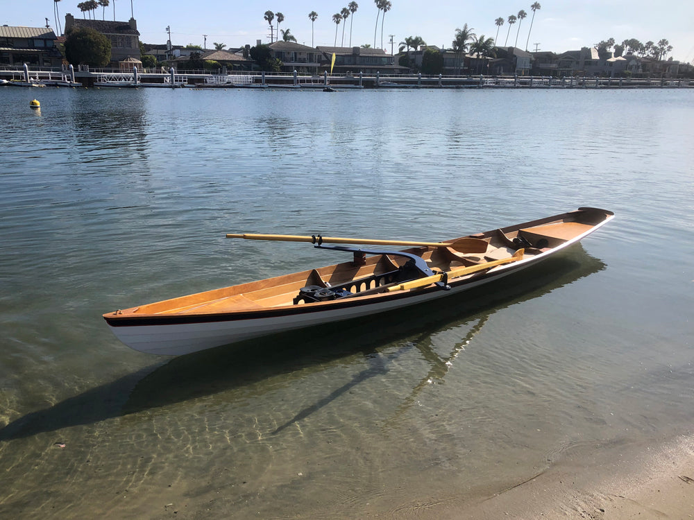 An Annapolis Wherry Tandem built by Chris H. floating on calm, clear water of Alamitos Bay in Long Beach, CA