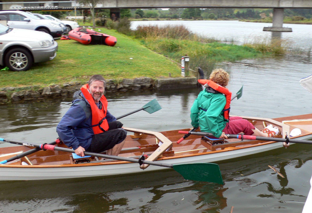 A couple rowing an Annapolis Wherry Tandem bu8ilt by Ian M on the Wairoa River, Tauranga, New Zealand