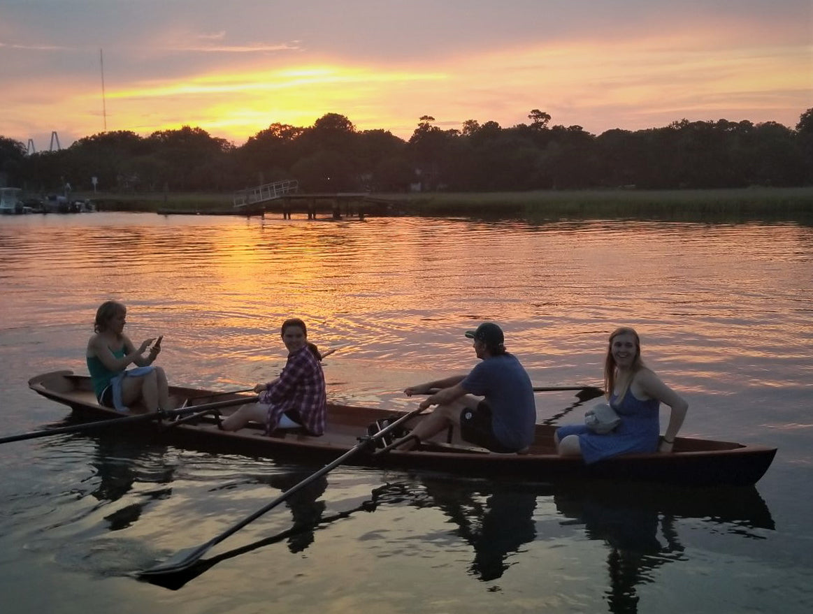 Four people enjoying a sunset row in an Annapolis Wherry Tandem built by Mick P. on Shem Creek, Charleston, SC