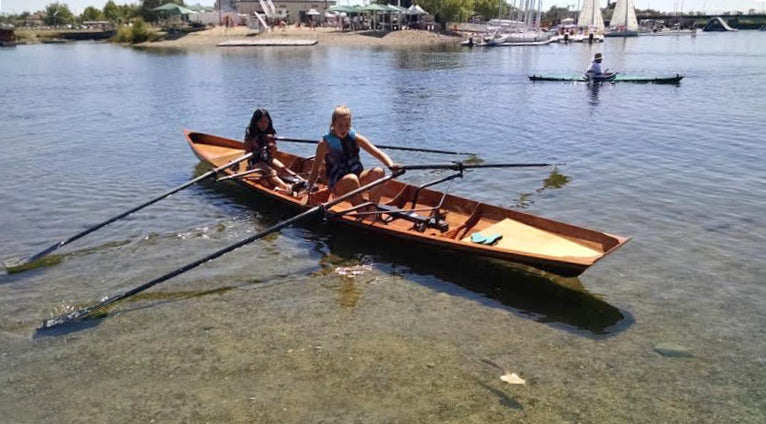 Two kids launching an Annapolis Tandem Wherry built by Craig and Molly G on Nimbus Lake