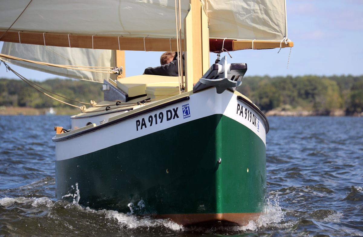 Close up view of an Autumn Leaves canoe yawl bow under sail
