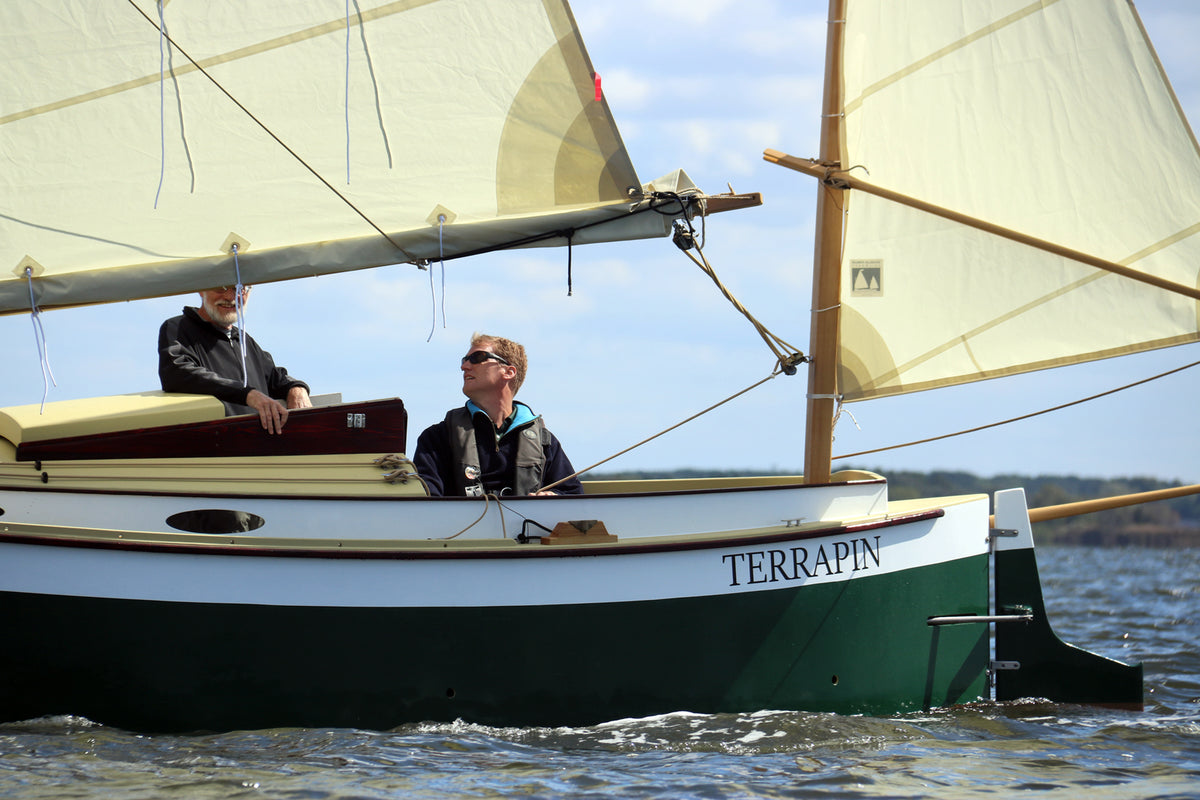 Designer John C. Harris at the helm of the Autumn Leaves canoe yawl 