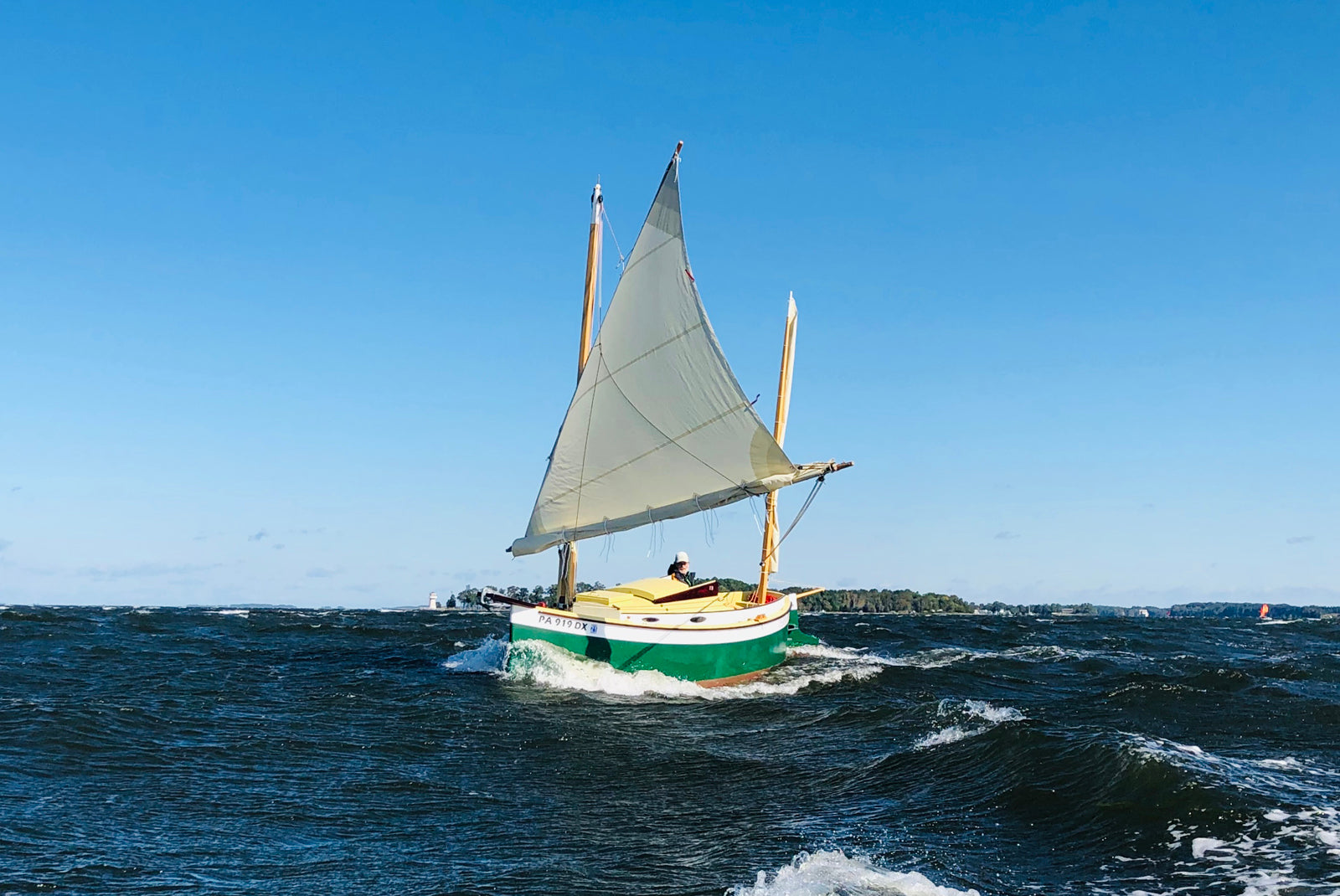 TIghtly reefed lug-rigged Autumn Leaves canoe yawl sailing on rough water