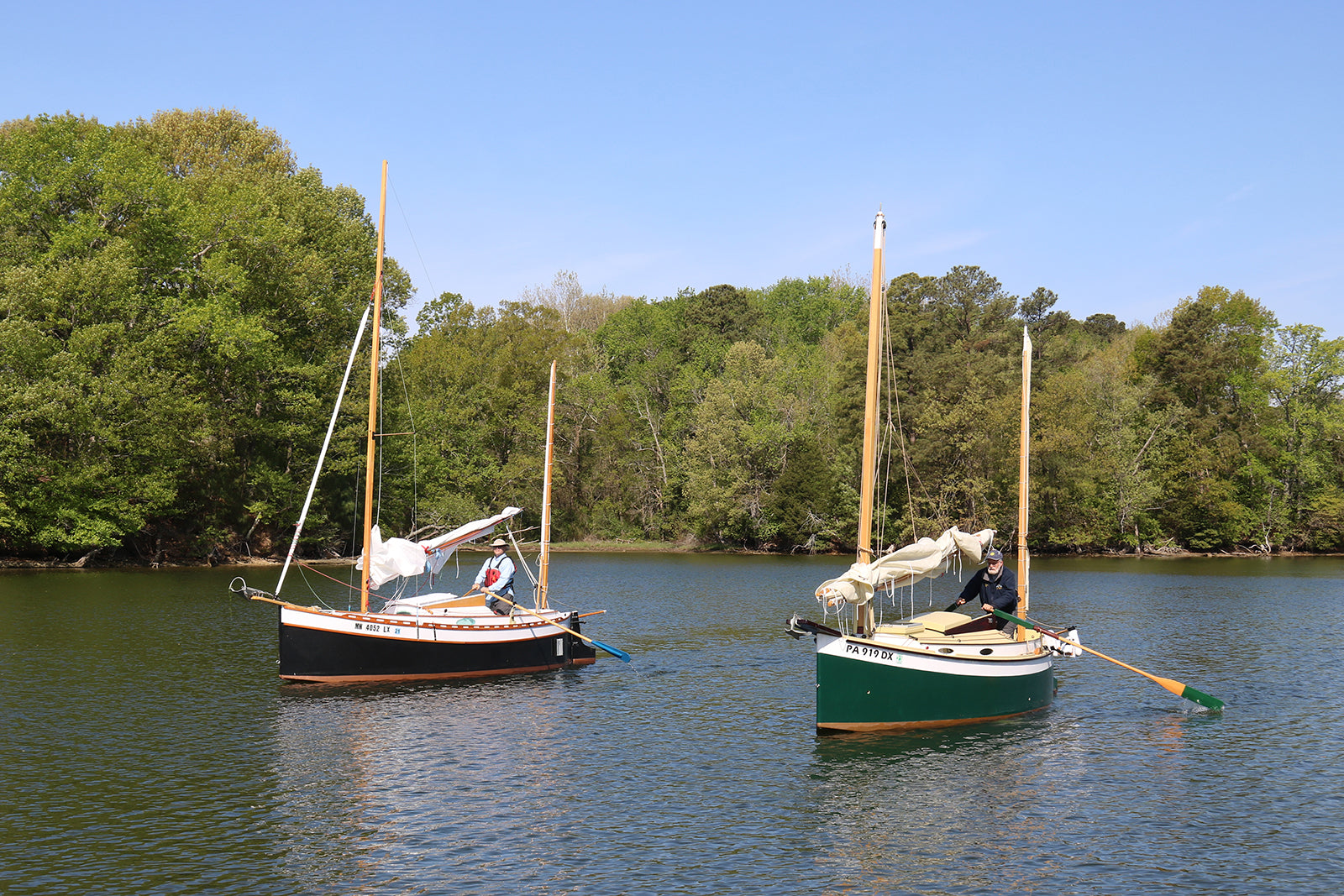 Two Autumn Leaves canoe yawls rowing into an anchorage.