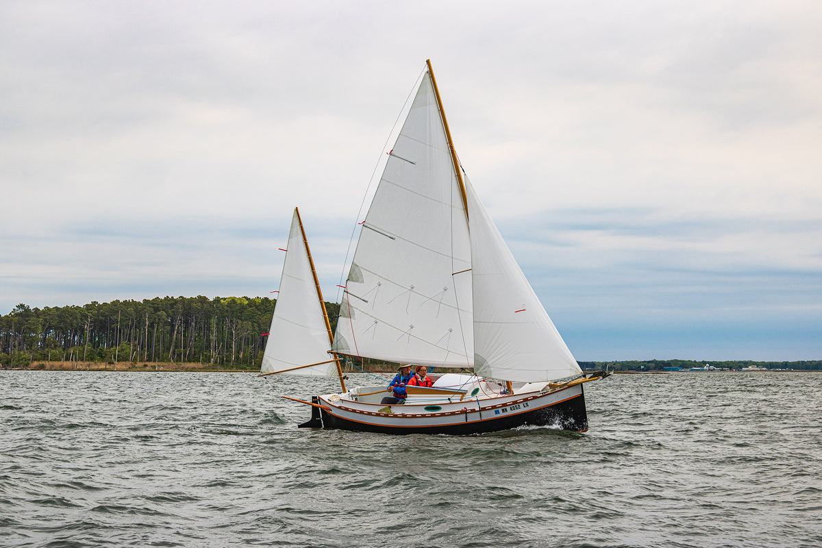 standard-rigged Autumn Leaves canoe yawl under full sail.
