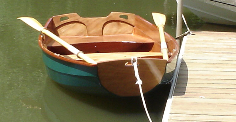 Roger B. painted the hull of his Eastport Pram green, which nicely offsets the varnish transoms and interior. 