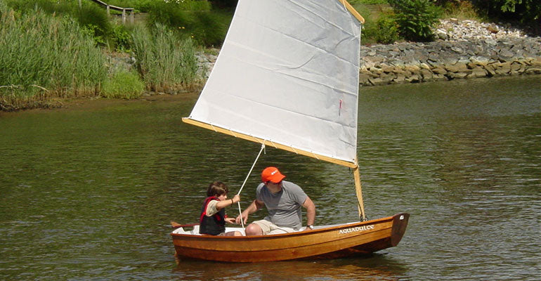 Father and son sailing an Eastport Pram