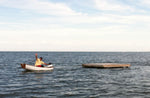George C. sent this image of him towing an 800 lb. dock with his Eastport Pram powered by a 2.4-hp outboard. Thumbnail
