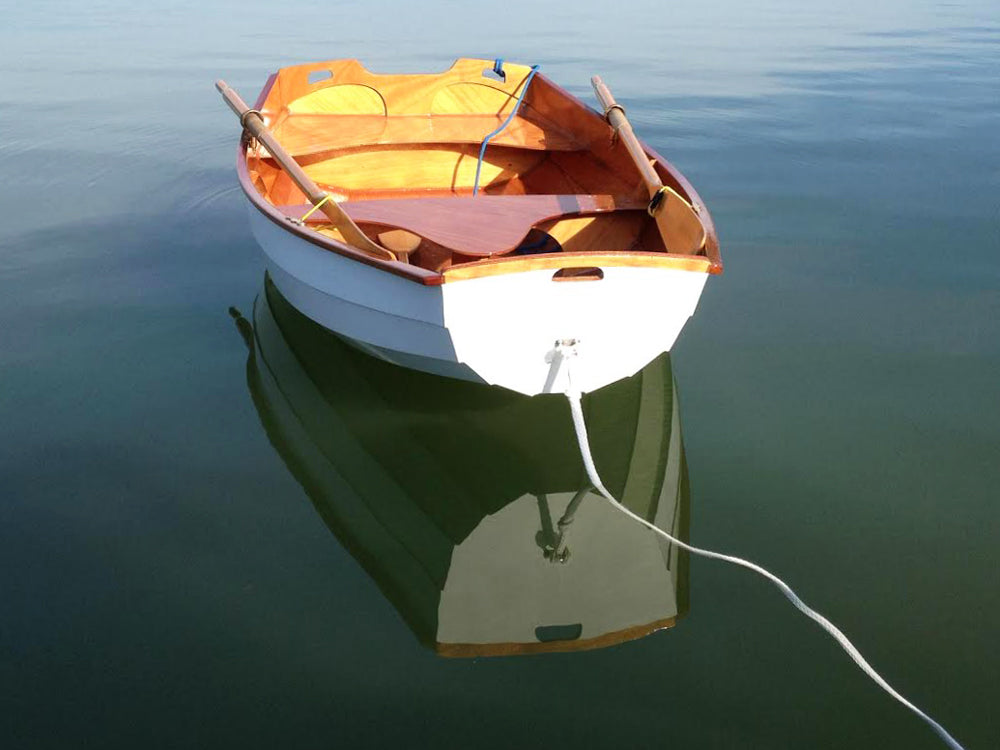 The graceful lines of the Eastport Pram are accentuated in its reflection.