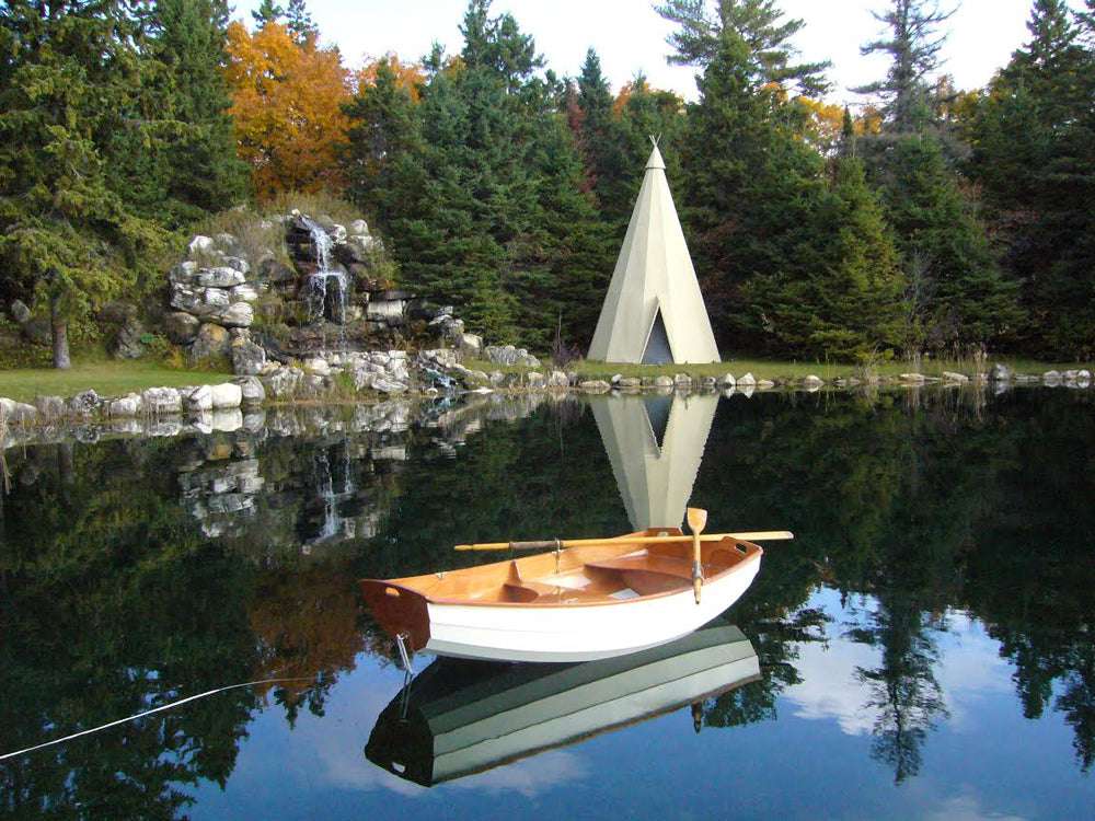 Dramatic reflections of an Eastport Pram, a tepee and a stone waterfall. 