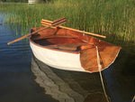Pat B. built this lovely Eastport Pram waiting peacefully in the shallows. Thumbnail
