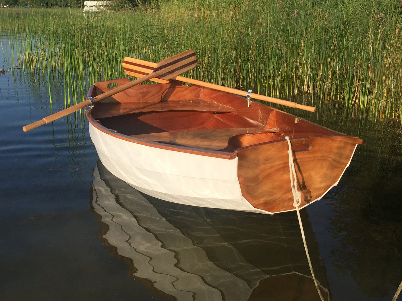 Pat B. built this lovely Eastport Pram waiting peacefully in the shallows.