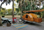 setting up camp in Fort Desoto Park with a CLC Teardrop Camper, Shearwater kayak, and a pair of chairs   Thumbnail