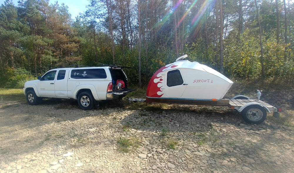 Fiery paint work on a CLC Teardrop Camper with an extended trailer.