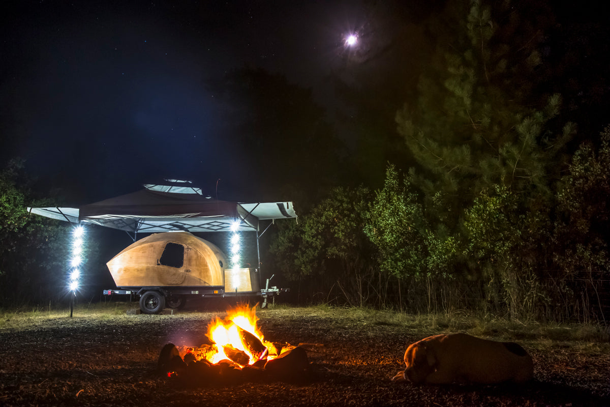 Griffin Moon photographed his CLC Teardrop Camper glowing by firelight and his portable lighting.