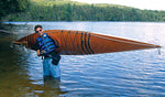 Chris J. carrying his Chesapeake 16 wooden kayak on his shoulder Thumbnail