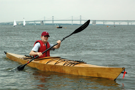 A young paddler testing out a Chesapeake 16 wooden kayak at OkoumeFest 2009
