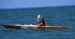 A woman paddling a Chesapeake 16 wooden kayak on the Chesapeake Bay Thumbnail