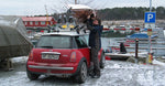 Hoisting a Chesapeake 16 wooden kayak onto the roof of a Mini in a winter boatyard Thumbnail