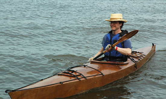 A man enjoying a paddle in a Chesapeake 16 wooden kayak at OkoumeFest 2009