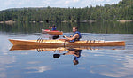 Paddling a Chesapeake 16 wooden kayak on a wooded lake Thumbnail